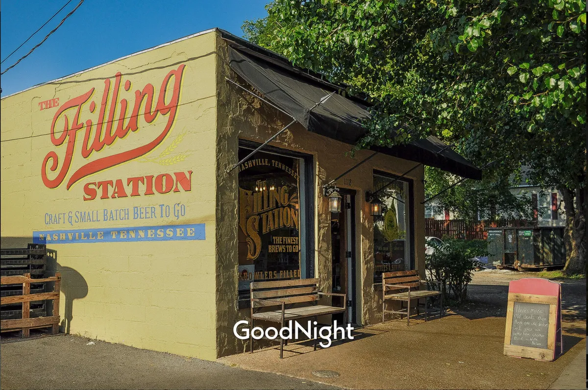An inviting exterior of 'The Filling Station' featuring a prominent sign, a window display, and a casual outdoor seating area. Patrons are seen chatting and enjoying drinks outside, embodying the spirit of friendly gatherings and local social scenes.