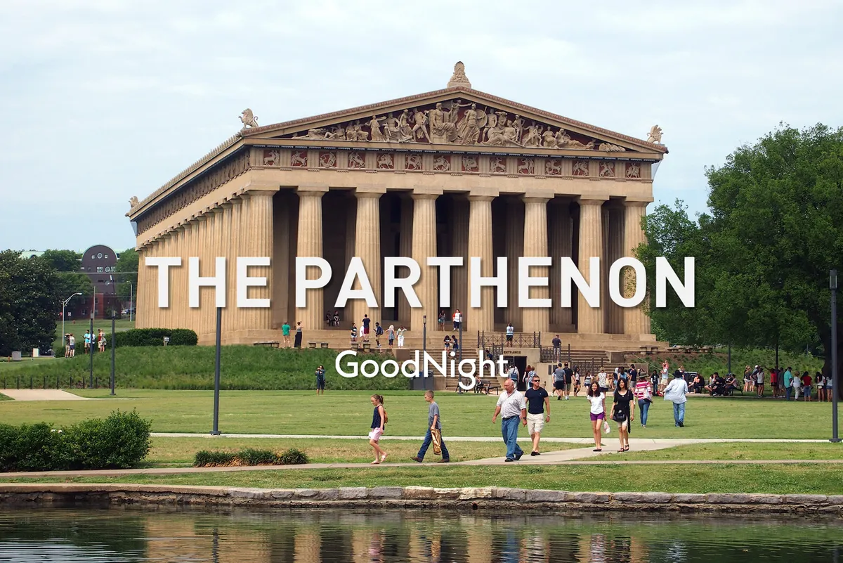 An exterior shot of The Parthenon set amidst a lush green lawn, with visitors of all ages enjoying the space. The joyful mood and historical architecture underscore the area's cultural significance and suitability for diverse family activities like sightseeing, photography, and picnicking.
